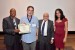 Dr. Bruce E. Peoples receiving the certificate and the medal of his designation as "Inter-Disciplinary Communication" Fellow of the IIIS.